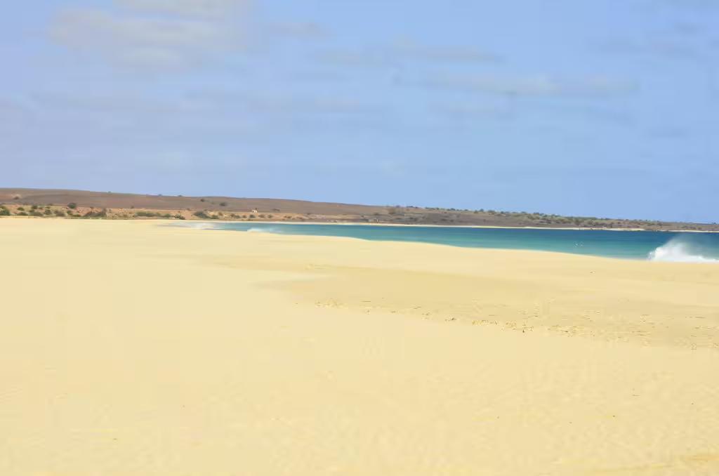 Expansive view of Santa Monica beach's pristine sands and turquoise waters on Boa Vista Island.