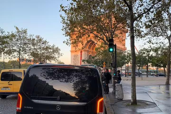 Mercedes van in city street offering Bologna airport to Ravenna cruise terminal transfer with scenic sunset view.