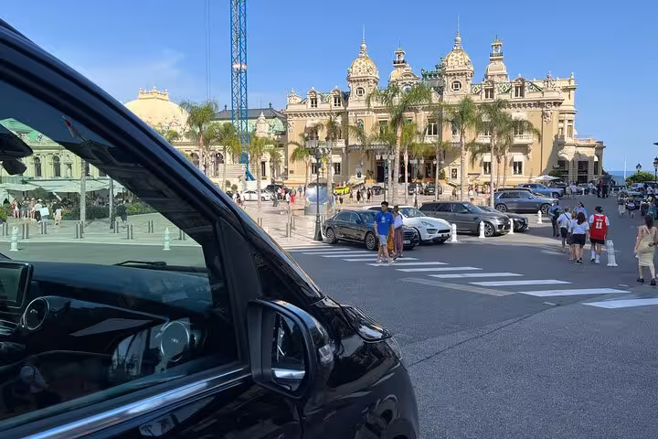 Sleek black vehicle ready for passengers near a bustling plaza, highlighting Bologna airport to Ravenna cruise transfer.