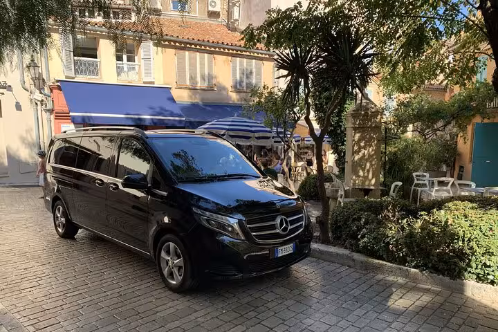 Black luxury van in charming street for Bologna to Ravenna cruise terminal transfer service.