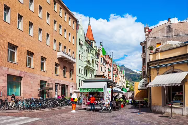 Bolzano old town street with gelato stand and colorful facades, perfect for a self-guided scavenger hunt tour