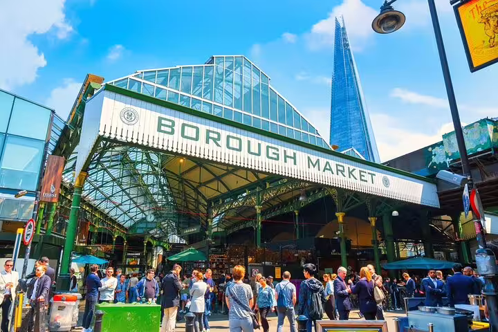 Borough Market entrance with crowds and The Shard behind, foodie stop on a full-day London tour with a local guide