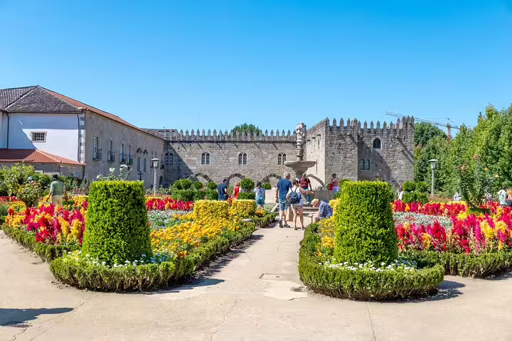 Vibrant garden at Braga's Santa Barbara Garden with tourists enjoying a scenic stop on a small group tour.