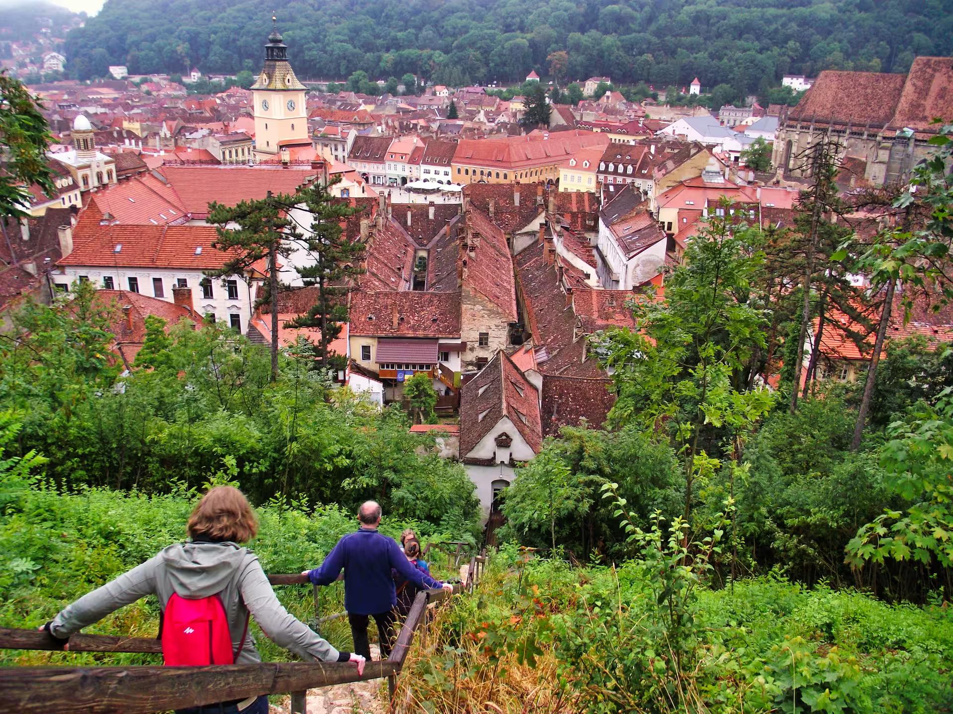 Tourists enjoying a panoramic view of Brasov old town red rooftops on a Best of Transylvania guided tour.