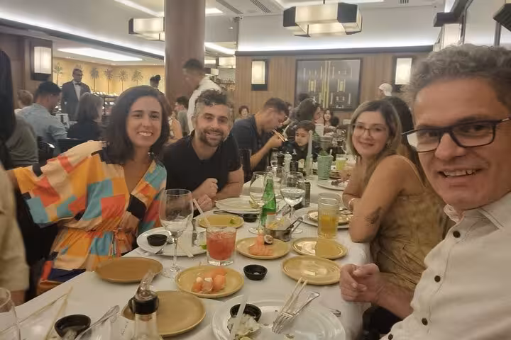 Happy diners savoring Brazilian BBQ and wine in a vibrant Rio restaurant atmosphere.