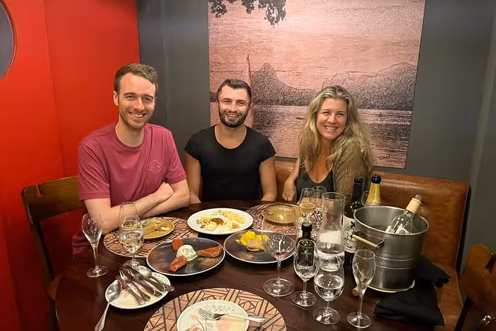 Guests enjoying a Brazilian BBQ and wine dinner in Rio with a variety of dishes and drinks.