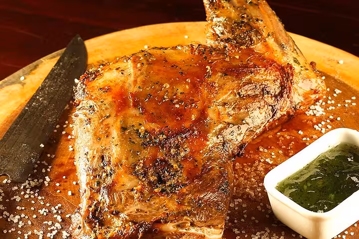 Succulent grilled steak with seasoning and sauce, showcasing authentic Brazilian BBQ flavors in Rio's dining scene.