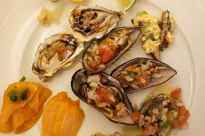 Gourmet plate of oysters and mussels with fresh salsa, part of Brazilian BBQ and wine dinner in Rio.