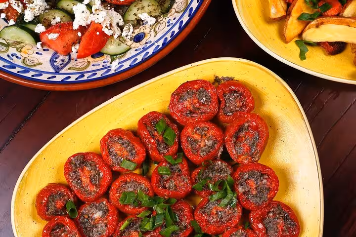 Colorful Brazilian side dishes featuring stuffed peppers, fresh salad, and roasted potatoes for Rio dining experience.
