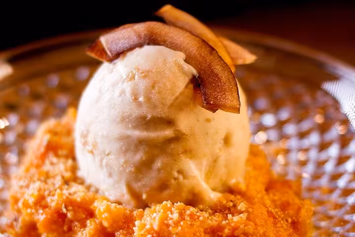 Gourmet Brazilian dessert with coconut ice cream and crunchy toppings served during a Rio guided dinner experience.