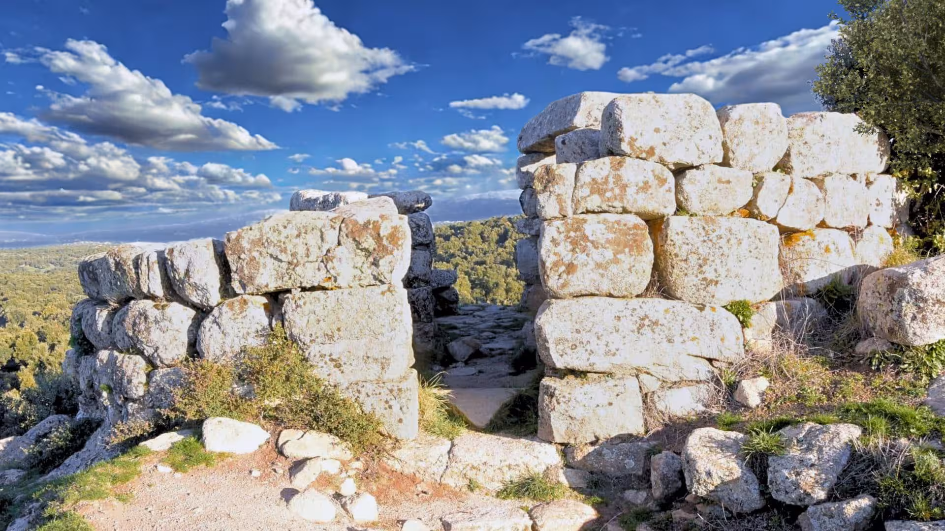 Explore ancient stone ruins under a vibrant sky at Loelle archaeological site, Buddusò guided tour destination.