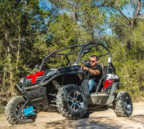 Driver on off-road buggy in southern Ibiza forest trail, guided Salinas nature day trip adventure