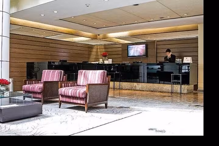 Modern hotel lobby with comfortable seating, featuring a welcoming reception desk for guests arriving in Rio de Janeiro.
