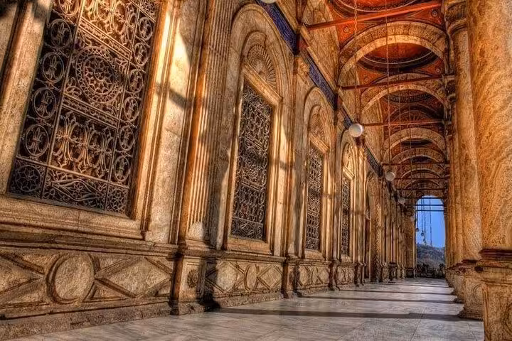 Historic Citadel corridor in Cairo with carved stone arches and lattice windows on Museum and Khan El Khalili tour