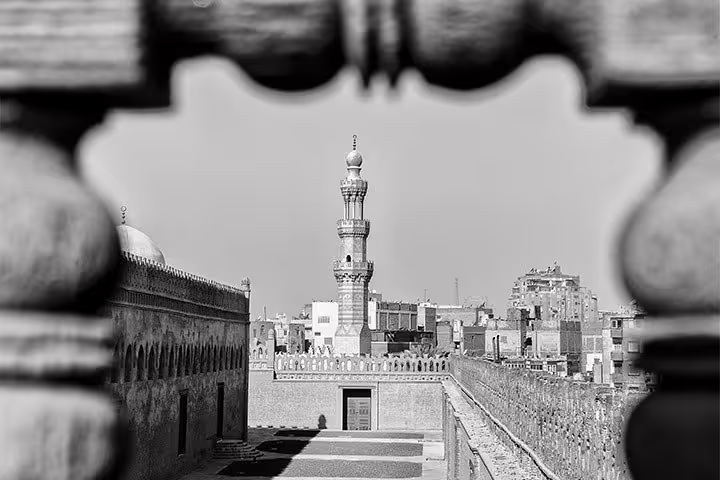 Black-and-white view from Cairo Citadel walls toward historic minaret on National Museum to Bazaars tour