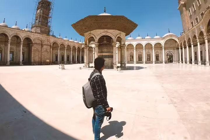 Traveler in Cairo Citadel courtyard near Mosque of Muhammad Ali, part of National Museum and Egyptian Museum tour