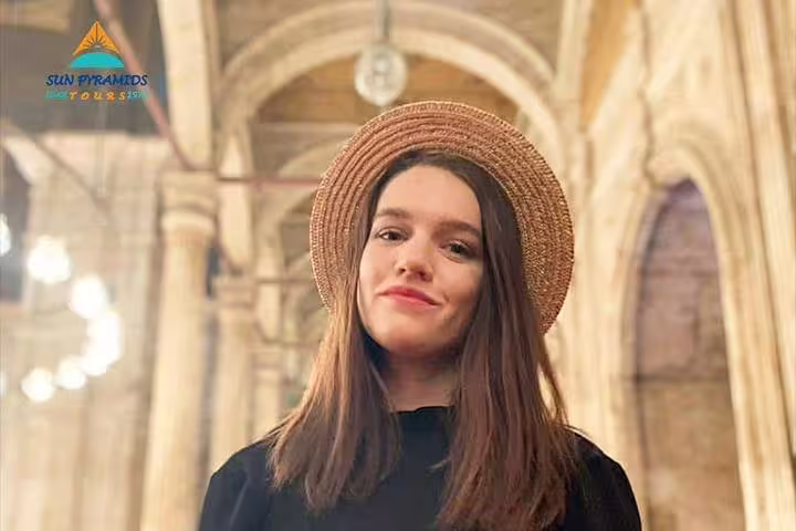 Visitor inside historic Cairo church, exploring Coptic Christian sites on Islamic and Christian Cairo day tour
