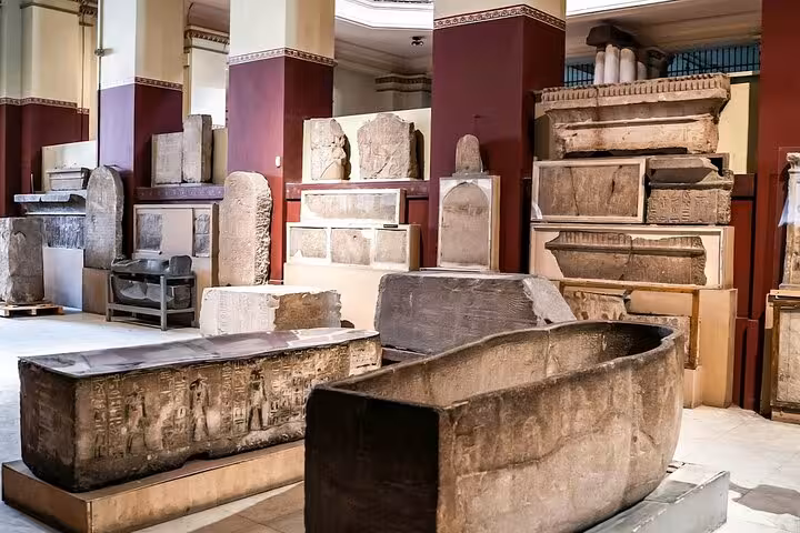 Ancient Egyptian stone sarcophagi display at Cairo museum, add-on stop for Tutankhamun mask visit tour