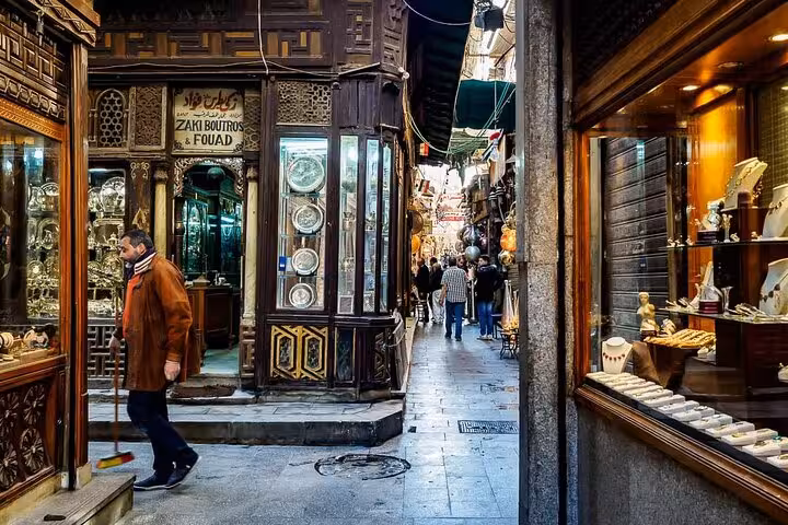 Narrow alley of Cairo’s Khan el Khalili bazaar on a private guided visit, browsing shops before local food