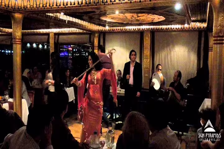 Belly dancer and live band performing on Cairo Nile dinner cruise, evening show with seated guests onboard