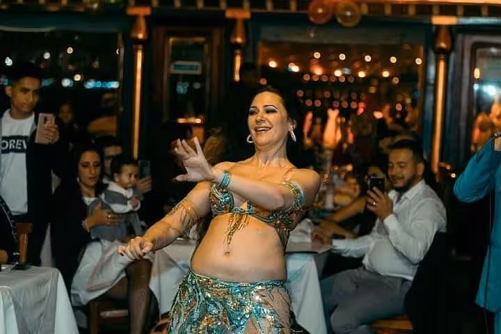 Belly dance performance on Cairo Nile dinner cruise boat with guests dining and enjoying live entertainment