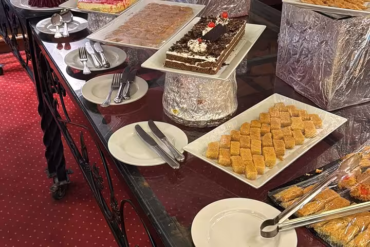 Dessert buffet on Cairo Nile dinner cruise with baklava and cakes, part of evening cruise with hotel pickup