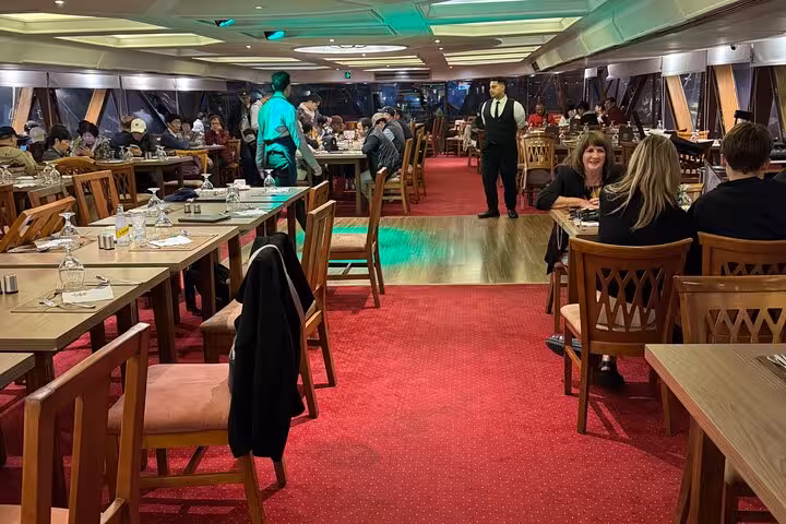 Dining room on Cairo Nile dinner cruise with live entertainment atmosphere, tables set for evening buffet dinner