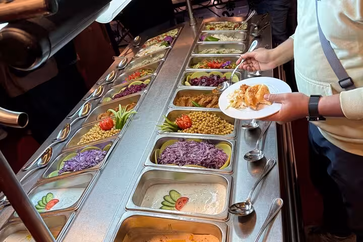 Guests serving Egyptian buffet on Cairo Nile dinner cruise, salad bar and pastries included with hotel pickup