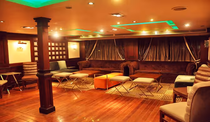 Elegant indoor salon seating on Cairo Nile dinner cruise boat, ideal for buffet dining and live shows