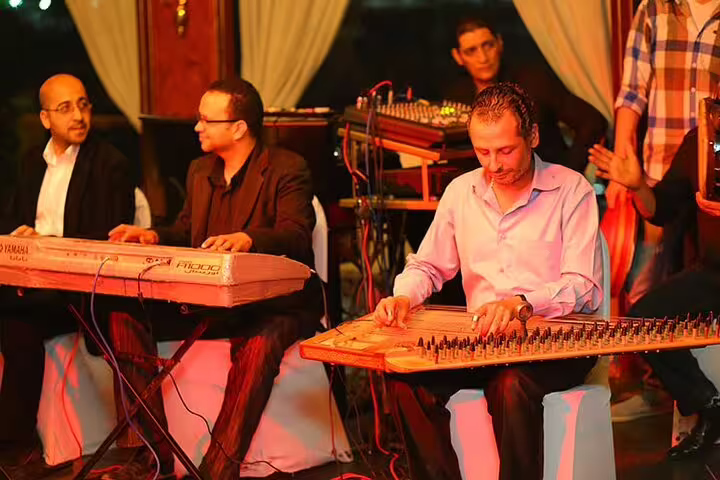 Live music show on Cairo Nile dinner cruise with traditional instruments, included in Giza pyramids museum combo tour