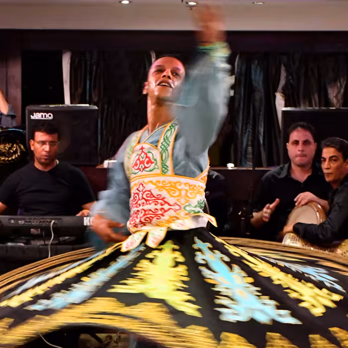 Tanoura whirling dervish show on Cairo Nile dinner cruise with live music and Egyptian entertainment onboard