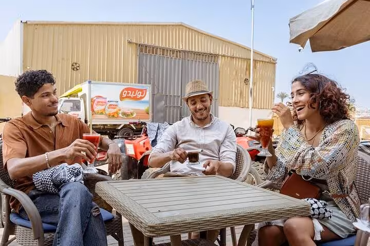 Tour guests relaxing with drinks after a Cairo desert quad ride, before Nile dinner cruise and Khan El Khalili visit