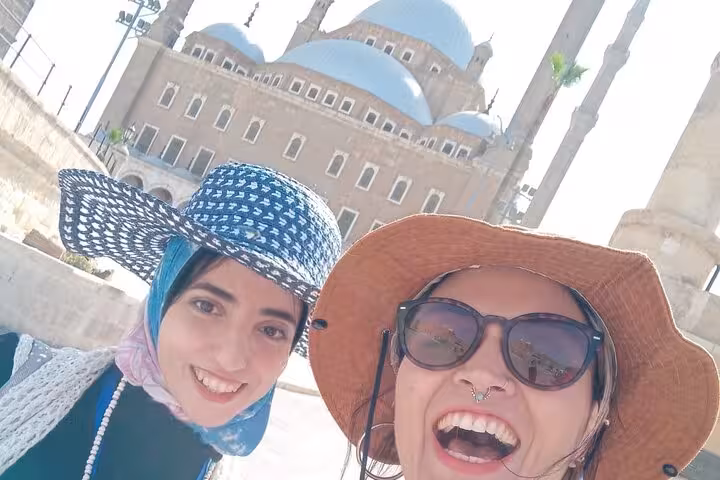Happy tourists in Cairo before a mosque, part of Saqqara Dahshur Memphis tour supporting stray dogs and cats