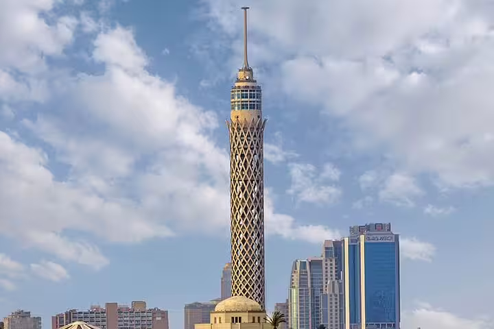 Cairo Tower rising over downtown skyline in daylight, highlight of El-Muizz Street and dinner tour