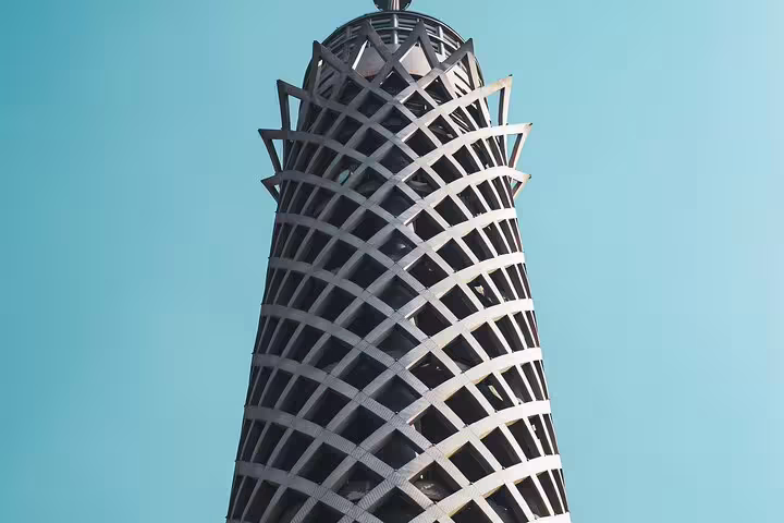 Close-up of Cairo Tower lattice design against blue sky, highlight of El-Muizz Street tour with dinner