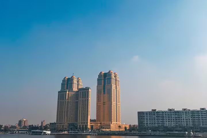 Nile skyline view near Cairo Tower, modern Cairo cityscape stop on El-Moez Street and pyramids tour