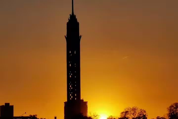Cairo Tower silhouetted at sunset, a highlight of the Giza Pyramids, El-Moez Street and Cairo Tower tour