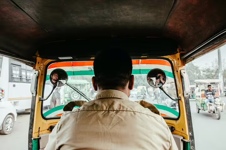 Riding a Cairo tuk-tuk through busy streets on a local market tour, showing authentic city transport views
