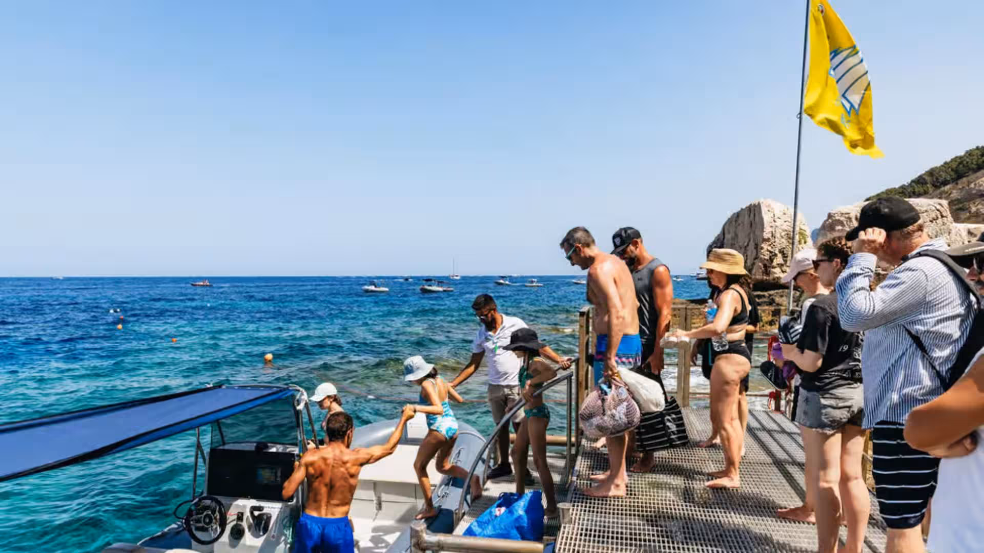 Tourists board a dinghy for an exciting adventure in the Gulf of Orosei, capturing the essence of Cala Gonone tours.
