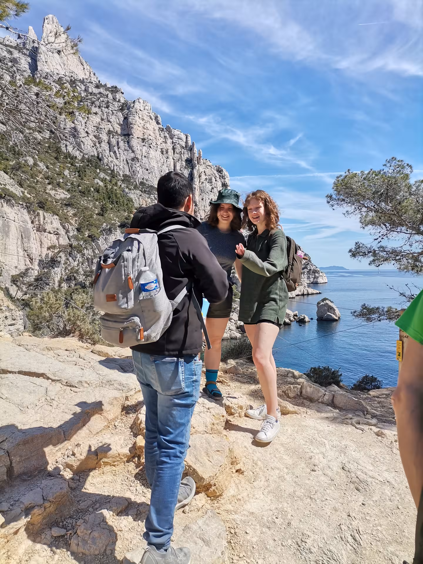 Guided hikers on a Calanques coastal trail near Marseille, Provence, with limestone cliffs and sea views