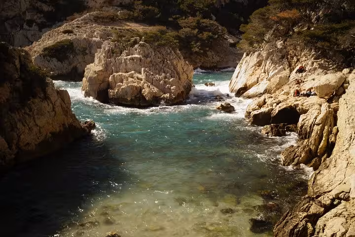 Turquoise cove and limestone cliffs in Calanques National Park on a guided hike from Marseille