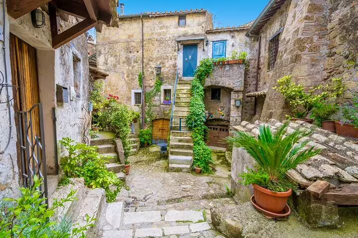 Picturesque medieval courtyard with stone steps and greenery in Calcata village on Rome, Calcata, Bomarzo VIP tour