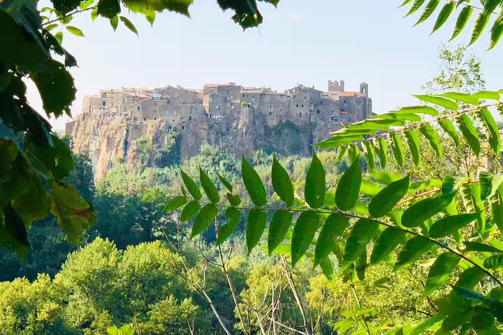 Medieval hilltop village of Calcata Vecchia near Rome framed by lush green forest on a VIP private guided tour
