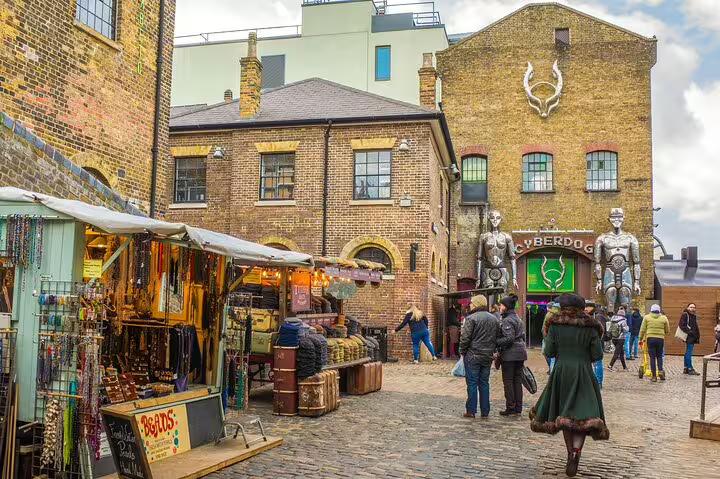 Visitors explore Camden Market in London, featuring eclectic shops, historic buildings, and vibrant street art on a private tour.