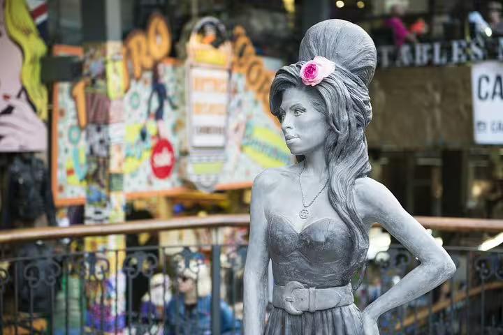Statue in Camden Market, London, showcasing vibrant street art and bustling atmosphere, highlighting unique tour attractions.