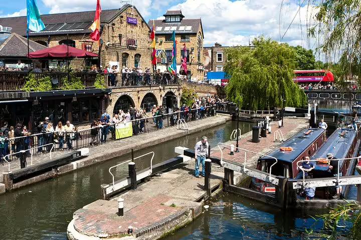 Bustling Camden Town scene with vibrant market, canal boats, and lively crowds, showcasing highlights of a London private tour.