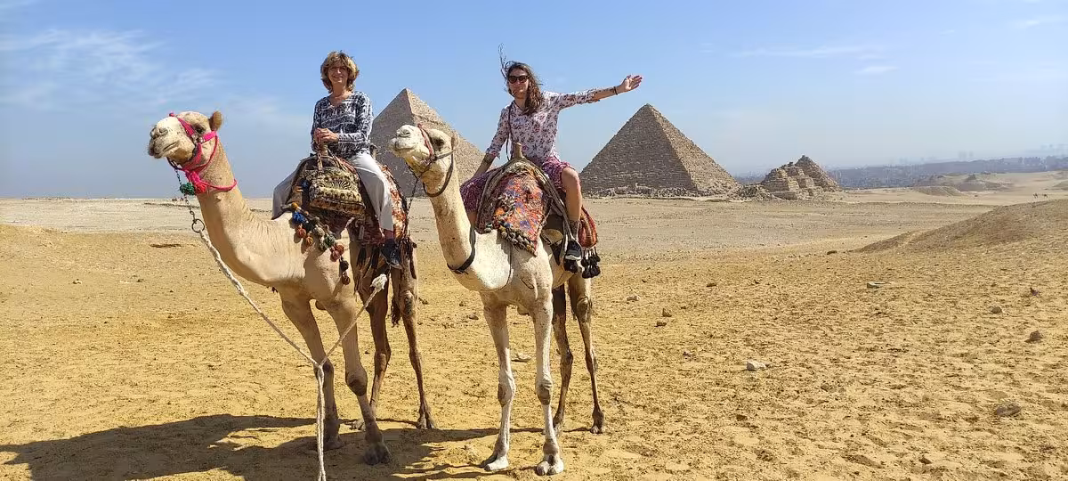 Camel ride at the Giza Pyramids in Cairo with desert views on a private guided tour experience