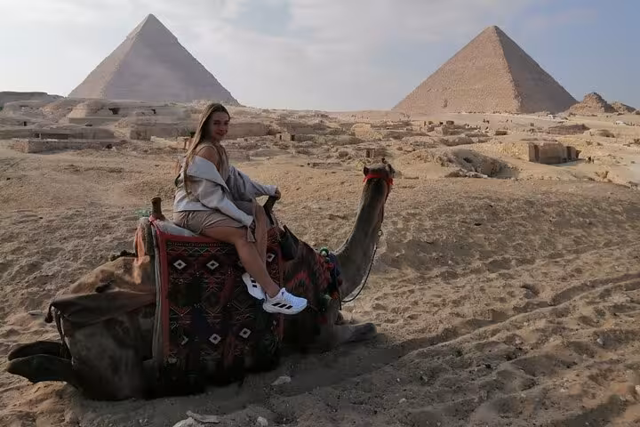 Camel ride at the Giza Pyramids in Cairo, Egypt, with panoramic desert view on a private tour