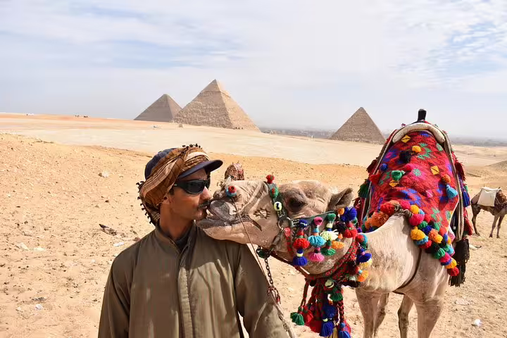 Camel ride at the Giza Pyramids near Cairo, colorful saddle on Egypt tours package for 6 days adventure