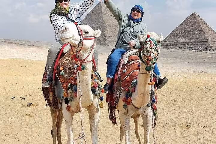 Camel ride at Giza Pyramids during private full-day Cairo tour from Hurghada with domestic flight